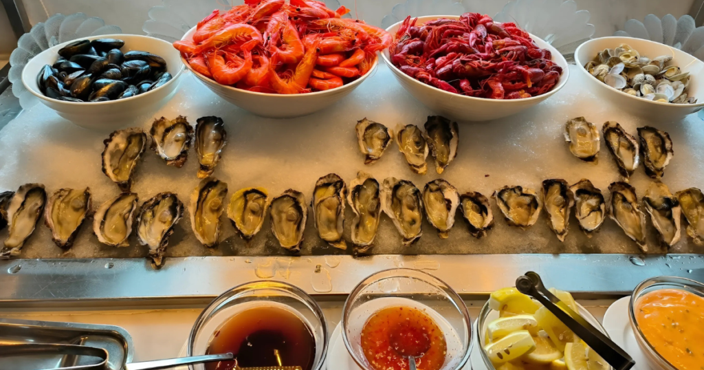 A lavish seafood buffet spread with fresh oysters, prawns, mussels, and crabs, beautifully arranged on ice at Royale.